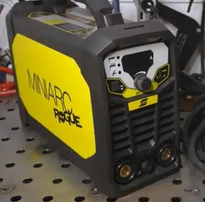 The Esab Rogue 180i welder displayed in a workshop setting, highlighting its compact design and striking yellow accent.